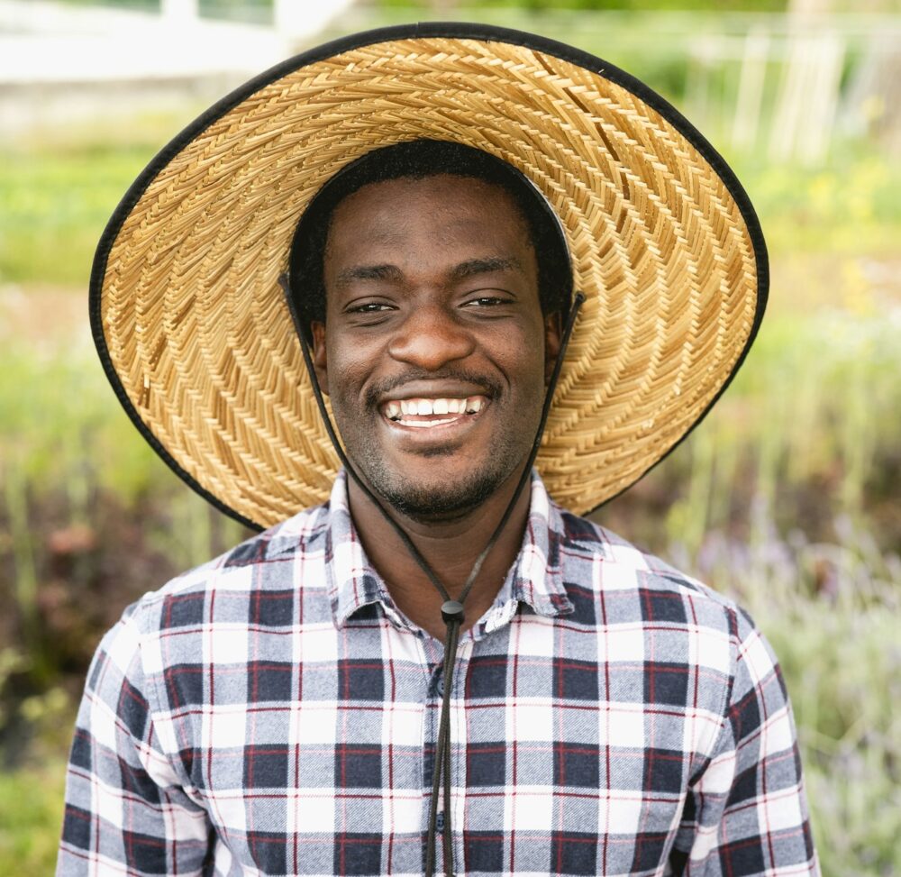 Happy African farmer working in farmhouse country - Farm people lifestyle concept